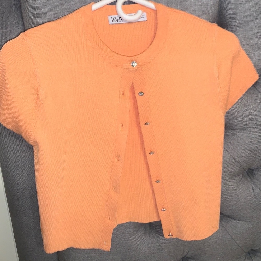 Orange shirt with super trendy buttons and silver sparkly long sleeve shirt